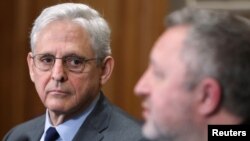 U.S. Attorney General Merrick Garland looks over at Ukrainian Prosecutor General Andriy Kostin as he speaks about the prosecution of war crimes in Ukraine committed by Russian forces, during a press conference at the Department of Justice in Washington, April 17, 2023.