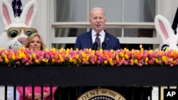 President Joe Biden speaks as first lady Jill Biden looks on at the White House Easter Egg Roll on the South Lawn of the White House, in Washington, April 1, 2024.