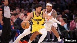 Tyrese Haliburton (0) des Indiana Pacers contrôle le ballon devant Miles McBride (2) des New York Knicks, États-Unis, le 19 mai 2024.