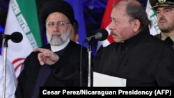 In this handout photo released by Nicaragua's Presidency, Nicaraguan President Daniel Ortega, right, speaks while standing next to Iran's President Ebrahim Raisi, left, in Managua, Nicaragua, June 13, 2023. (AFP PHOTO/Nicaraguan Presidency/Cesar Perez)