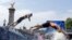FILE - Athletes dive back into the Seine River for the second lap of the swim portion at the men's individual triathlon competition at the 2024 Summer Olympics, in Paris, France, July 31, 2024. 