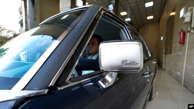 Khosro Dahaghin drives out his restored Cadillac Seville at his dealership store in Roudehen, some 30 miles (45 kilometers) east of downtown Tehran, Iran, June 7, 2023.