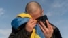 FILE - A Ukrainian prisoner of war cries while calling his relatives after a prisoner exchange on the Ukrainian-Russian border, Jan. 31, 2024. U.N.-backed human rights experts said March 15 they have new evidence of “horrific” torture of Ukrainian prisoners of war.