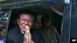 Kem Sokha, a founder of the Cambodia National Rescue Party, offers a greeting from his car in front of his house in Phnom Penh, Cambodia, March 3, 2023. 