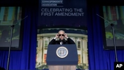 President Joe Biden puts on sunglasses after making a joke about becoming the 'Dark Brandon' persona during the White House Correspondents' Association dinner at the Washington Hilton in Washington, April 29, 2023.