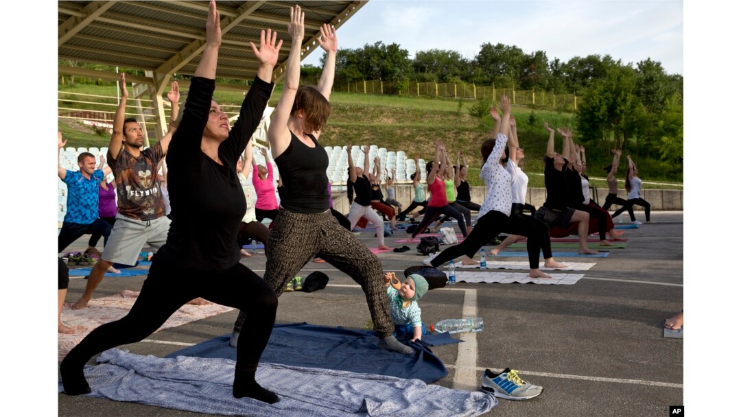 fiLE - Seorang bayi bermain di dekat ibunya saat para siswa Yoga mengikuti kelas yoga luar ruangan di Taman Nasional Germia di ibu kota Kosovo Pristina, 16 Juni 2016. (AP/Visar Kryeziu)
