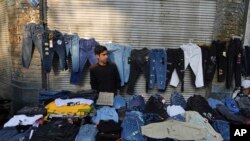 A street vendor waits for customers in Tehran, Iran, ahead of the Persian New Year, known as Nowruz, March 15, 2023. Crippling Western sanctions, on top of decades of economic mismanagement, have plunged the country into a severe crisis.