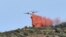 A plane drops fire retardant over a forest fire on a hill near the village of Banyuls-sur-Mer, southwestern France on April 16, 2023.