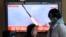 A TV screen shows a file image of a North Korean missile launch during a news program broadcast at the Seoul Railway Station in Seoul, South Korea, Feb. 24, 2023. 