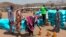 FILE - Sudanese refugees displaced by the conflict in Sudan gather to receive food staples from aid agencies at the Metche Camp in eastern Chad, March 5, 2024. 