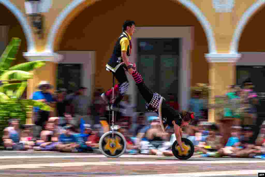 Cheeky and Daiki of the Witty Look unicycle riders of Japan perform during Puerto Rico Circo Fest in old San Juan, March 12, 2023.