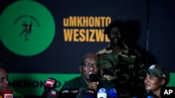 FILE - Former South African President Jacob Zuma speaks as his daughter Duduzile Zuma-Sambudla listens during a press conference in Soweto, South Africa, Dec. 16, 2023. 