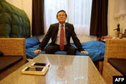 FILE - This photo taken on October 7, 2016 shows Cambodia's opposition party deputy leader Kem Sokha posing on his bed inside the Cambodia National Rescue Party (CNRP) headquarters in Phnom Penh. Facing prison over an alleged sex scandal, he says he is the latest target of a government which is using the courts as a weapon to pick off its main rivals ahead of elections in 2018.