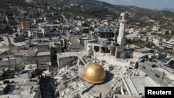 FILE - The remains of a mosque in the aftermath of a deadly earthquake in Idlib province, Syria, Feb. 24, 2023. Sources say Iran has used earthquake relief flights to bring weapons and military equipment into its strategic ally Syria.