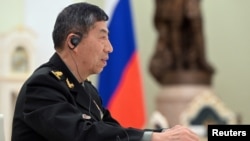 FILE - Chinese Defense Minister Li Shangfu attends a meeting with Russian President Vladimir Putin and Defense Minister Sergei Shoigu in Moscow, April 16, 2023. (Sputnik/Pavel Bednyakov/Pool via Reuters.)