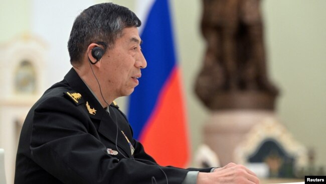 FILE - Chinese Defense Minister Li Shangfu attends a meeting with Russian President Vladimir Putin and Defense Minister Sergei Shoigu in Moscow, April 16, 2023. (Sputnik/Pavel Bednyakov/Pool via Reuters.)