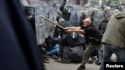 NATO Kosovo Force soldiers clash with local Kosovo Serb protesters at the entrance of the municipality office in the town of Zvecan, Kosovo, May 29, 2023. 