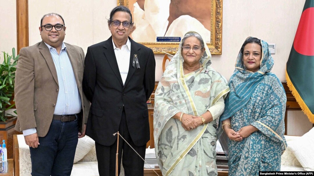 This handout photo released by the Bangladesh Prime Minister's Office on Aug. 10, 2023, shows Akam Sofyol Anam (second from left), his wife, right, and son, left, with Bangladesh Prime Minister Sheikh Hasina (second from right) in Dhaka, Bangladesh, after he was freed.