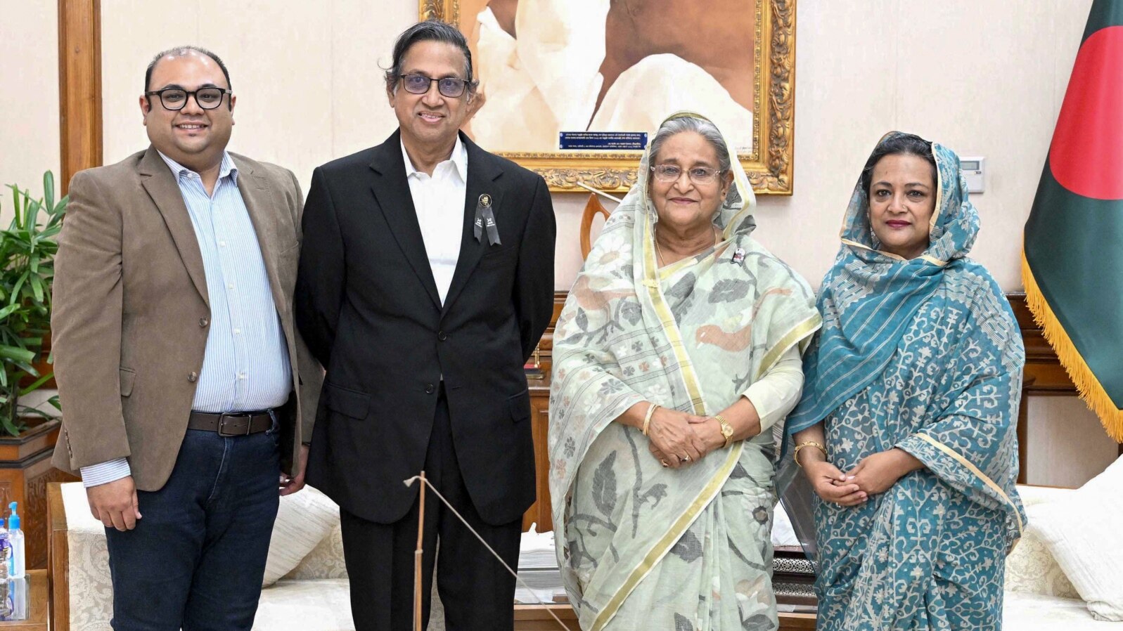 This handout photo released by the Bangladesh Prime Minister's Office on Aug. 10, 2023, shows Akam Sofyol Anam (second from left), his wife, right, and son, left, with Bangladesh Prime Minister Sheikh Hasina (second from right) in Dhaka, Bangladesh, after he was freed.