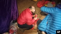 American caver Mark Dickey, left, 40, talks to a colleague inside the Morca cave near Anamur, southern Turkey, Sept. 7, 2023. 