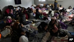 FILE - Syrians gather at a shelter in Antakya, southeastern Turkey, Feb. 10, 2023. For Syrians fleeing the violence back home, the earthquake that struck in Turkey and Syria is but the latest tragedy.