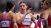 Krystsina Tsimanouskaya, of Poland, gestures as she talks with teammates following their women's 4x100-meter relay heat at the 2024 Summer Olympics, Aug. 8, 2024, in Saint-Denis, France.