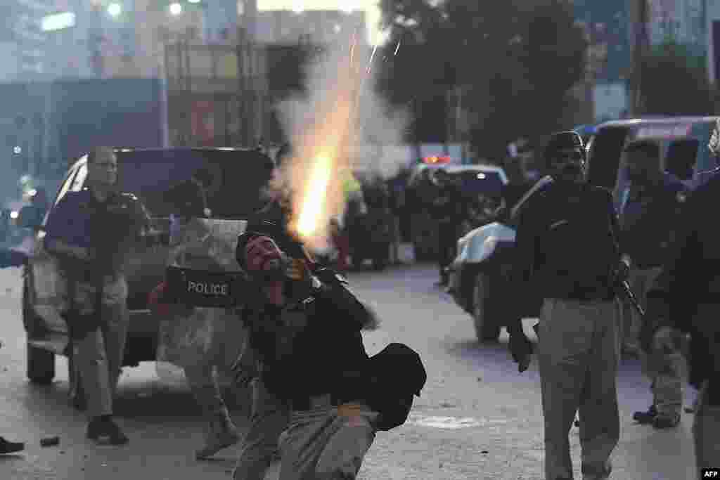 Police fire tear gas shells toward Pakistan Tehreek-e-Insaf party activists and supporters of former Pakistan&#39;s Prime Minister Imran during a protest in Karachi of the arrest of their leader. Khan was arrested in connection with a graft case.