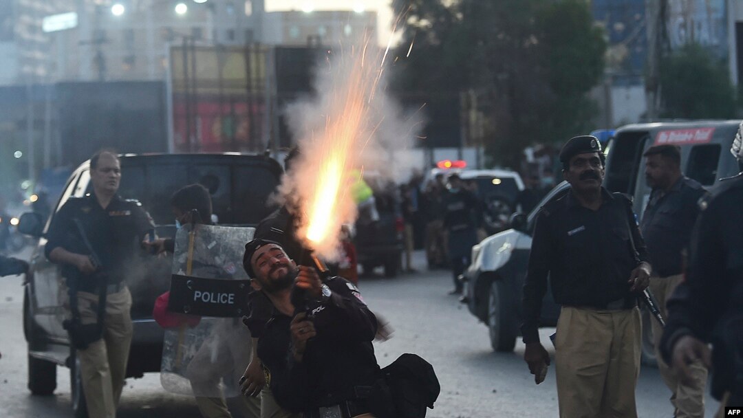 Police fire tear gas shells towards Pakistan Tehreek-e-Insaf (PTI) party activists and supporters of former Pakistan's Prime Minister Imran during a protest against the arrest of their leader, in Karachi, May 9, 2023.