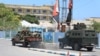 FILE - An armored personnel carrier (APC) drives in a street near a hotel in Mogadishu on March 15, 2024. Sporadic explosions and gunfire rang out from a popular hotel in the Somali capital early on that day.