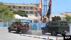 FILE - An armored personnel carrier (APC) drives in a street near a hotel in Mogadishu on March 15, 2024. Sporadic explosions and gunfire rang out from a popular hotel in the Somali capital early on that day.