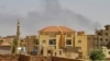 FILE - Smoke rises above buildings in Khartoum on May 12, 2023, as fighting between the forces of two rival generals continues. 