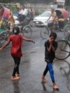 Children cool themselves in the water, sprayed from a spray cannon by Dhaka North City Corporation, during a countrywide heatwave in Dhaka, Bangladesh, April 28, 2024. 