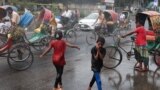 Children cool themselves in the water, sprayed from a spray cannon by Dhaka North City Corporation, during a countrywide heatwave in Dhaka, Bangladesh, April 28, 2024. 
