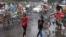 Children cool themselves in the water, sprayed from a spray cannon by Dhaka North City Corporation, during a countrywide heatwave in Dhaka, Bangladesh, April 28, 2024. 