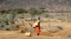 FILE - A Samburu woman fetches water during a drought in Loolkuniyani Primary School, Samburu County, Kenya, Oct. 16, 2022.