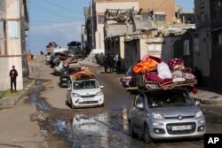 Palestinians flee the Israeli ground offensive in the central Gaza Strip, heading south through Deir al Balah, Jan. 5, 2024.