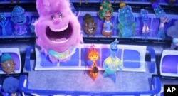 This image released by Disney/Pixar Studios shows characters Gale, center left, Ember, center, and Wade, right, in a scene from "Elemental."