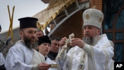Metropolitan Epiphanius, the head of the Ukrainian Orthodox Church, blesses water during a traditional Epiphany celebration in Kyiv, Ukraine, Jan. 6, 2024.
