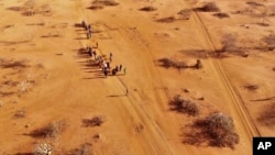 FILE - People arrive at a displacement camp on the outskirts of Dollow, Somalia, Sept. 21, 2022 amid a drought.