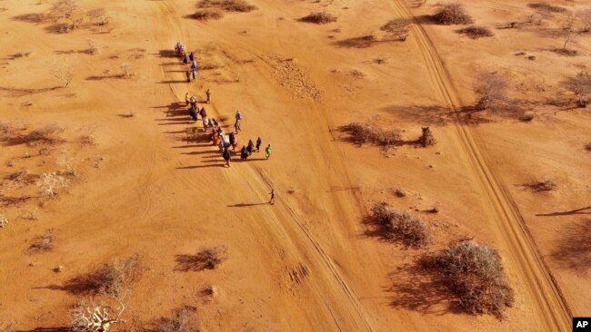 FILE - People arrive at a displacement camp on the outskirts of Dollow, Somalia, Sept. 21, 2022 amid a drought.