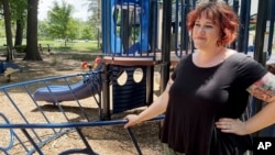 Whitney Wilson, a 39-year-old therapist, watches her three children play at a park in the Kansas City suburb of Prairie Village, Kansas, on June 14, 2024.