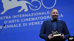 Greek director Yorgos Lanthimos poses with the Golden Lion award for the best film 'Poor Things' during the closing ceremony for the 80th edition of the Venice Film Festival in Venice, Italy, Sept. 9, 2023.