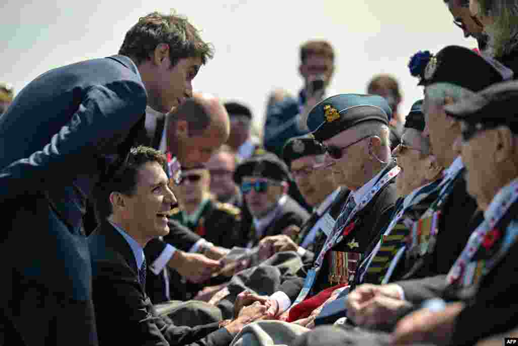 France&#39;s Prime Minister Gabriel Attal (L), Canadian Prime Minister Justin Trudeau (C) and Prince Britain&#39;s Prince William, the Prince of Wales (L) speak with WWII veterans during the Canadian commemorative ceremony marking the 80th anniversary of the World War II &quot;D-Day&quot; Allied landings in Normandy, at the Juno Beach Centre near the village of Courseulles-sur-Mer, in northwestern France, June 6, 2024.&nbsp;
