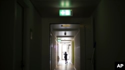 A boy walks down the hallway of a shelter for new asylum seekers near the central registration in Berlin, Germany, Sept. 25, 2023.