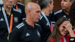 FILE - President of Spain's soccer federation, Luis Rubiales, center, stands with Spain's Women's World Cup soccer team after their World Cup victory at La Moncloa Palace in Madrid, Spain, Aug. 22, 2023.