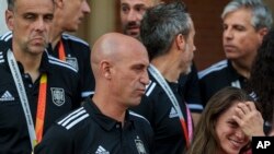 President of Spain's soccer federation, Luis Rubiales, center, stands with Spain's Women's World Cup soccer team after their World Cup victory at La Moncloa Palace in Madrid, Spain, Aug. 22, 2023. 