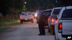 Police respond to the scene of a shooting, April 29, 2023, in Cleveland, Texas. A man killed several including an 8-year-old, after the family asked him to stop firing his gun.