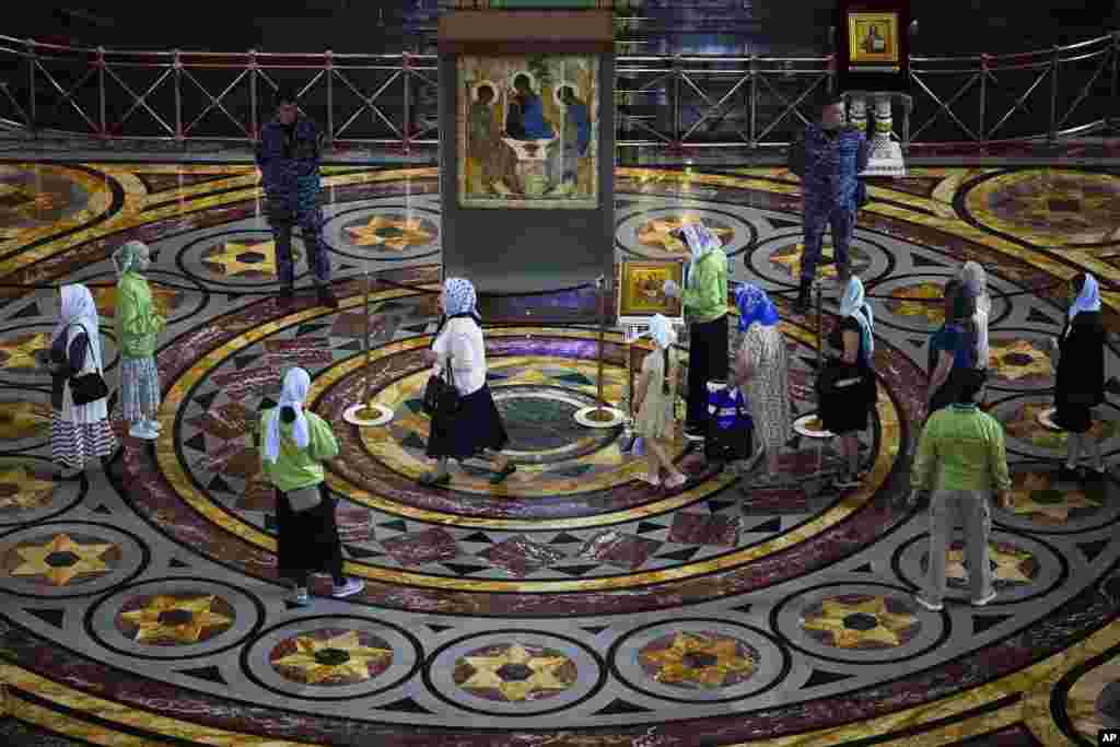 People look at the Trinity icon by Andrei Rublev at Christ the Savior Cathedral in Moscow, Russia.