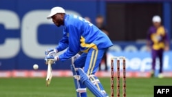 FILE - Sachin's Blaters batsman Curtly Ambrose plays a shot off Warne's Warriors bowler Wasim Akram during the first of a three-match T20 series at the Citi Field in New York on Nov. 7, 2015.