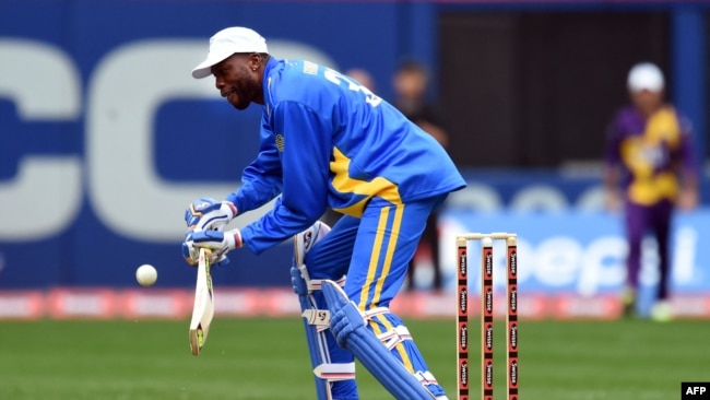 FILE - Sachin's Blaters batsman Curtly Ambrose plays a shot off Warne's Warriors bowler Wasim Akram during the first of a three-match T20 series at the Citi Field in New York on Nov. 7, 2015.